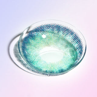 Macro shot of a blue contact lens, showing the dark outer limbal ring and dotted pattern designed to enhance eyes, on a light background