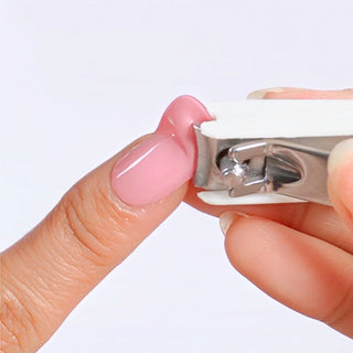Using a nail cutter to trim excess EyeCandys Gel Nail Stickers for a seamless and precise nail art application