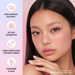 A woman with long dark hair and natural makeup poses with her hand near her chin, wearing EyeCandys Pink Label Marshmallow Brown contact lenses. Nearby icons highlight free shipping, 30-day guarantee, reward points, and subscription savings.