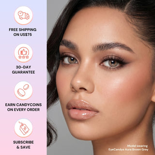 Close-up of a woman with flawless makeup and light brown eyes wearing EyeCandys Aura Brown Grey contacts. Benefits: free shipping on US$75+, 30-day guarantee, rewards, and subscribe & save options from EyeCandys.