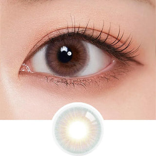 A close-up of a brown eye with long lashes wearing Olola Blow Sunset Pink contact lenses by Olola for a natural look. Below, an enlarged image of the lens is shown; suitable for those needing myopia prescription.