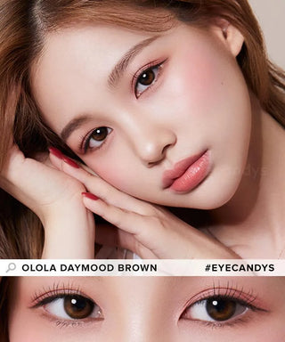A woman with flawless skin and subtle makeup wears Olola Daymood Brown contact lenses by Olola, designed for dark eyes. The close-up shows their soft hue. Text: "Olola Daymood Brown #Eyecandys." Myopia prescription available.