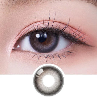 A close-up of a person’s brown eye with long lashes wearing Olola Daymood Grey contact lens by Olola for myopia; below is a separate image of the same lens.