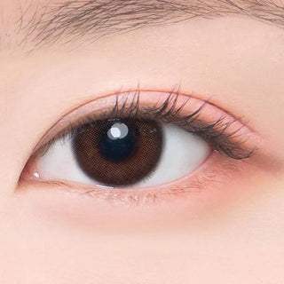 Macro shot of an eye wearing the DooNoon Touch Brown prescription colour contact lens, showing the multi-colored detail and natural effect on dark brown eyes.