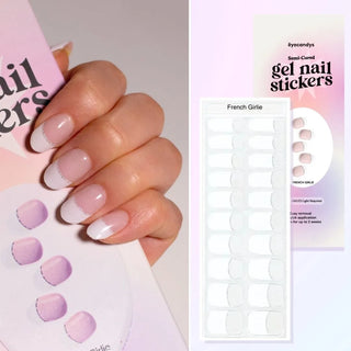 A hand with EyeCandys Gel Nail Sticker French Girlie applied, showcasing stylish French tips. The image features semi-cured gel nail strips, perfect for creating polished gel nails at home. These gel nail stickers require UV light for curing and offer a convenient, long-lasting alternative to traditional nail polish