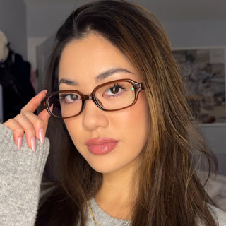 Close-up portrait of model wearing EyeCandys Side Eye rectangular glasses, lightweight TR frame, medium fit