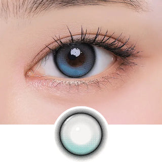 Close-up of an eye wearing i-Girl One Pick Balance Forest Tea Blue contact lenses by i-Girl, featuring a dark rim and gentle gradient. An enlarged view below highlights the lens’s vibrant circular pattern and color details.
