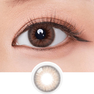 A close-up shows a brown eye with long lashes wearing Olola Dazzling 1-Day Rosie Hazel (10pk) color contacts. Beneath, an enlarged image highlights the lens's unique pattern and warm brown hue by Olola.