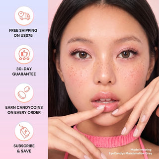 A woman with long brown hair and natural makeup wears EyeCandys Pink Label Marshmallow Grey contacts and touches her face. Icons show free shipping over $75, 30-day guarantee, rewards, and subscription savings.