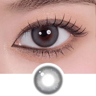 Asian eye wearing Melinoe 1-Day Beige Blue coloured contact lens on top of a dark iris, with natural glitter eyeshadow and long eyelashes.