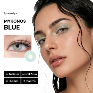 A woman with bluish-green contact lenses, subtle pastel eyeshadow, and glossy lips looks at the camera. Next to her are product details and an image of the EyeCandys Pink Label Mykonos Blue color contacts.