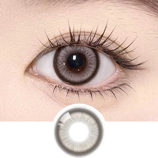 A close-up of an eye wearing Olola Meow Vivid Aby Brown contact lens by Olola, featuring long eyelashes and smooth skin. Below, an enlarged image of the same lens, available in myopia prescription for clear vision and style.