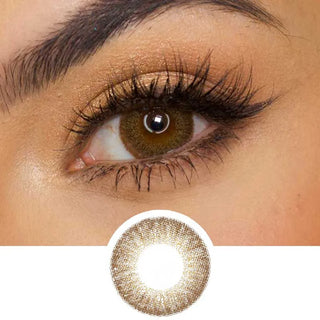A close-up of an eye with gold eyeshadow and long dark lashes wearing EyeCandys Pink Label Vintage Brown for a subtle enlarging effect, with a circular image below showing the lens’s vintage-inspired design.