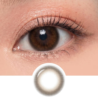 A close-up of a brown eye with long lashes wears EyeCandys Pink Label Marshmallow Brown lenses for a natural look. Below, the lens design shows a soft brown pattern—perfect for everyday wear.