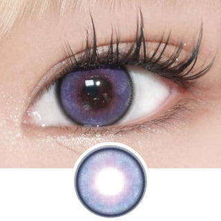 A close-up of an eye with long lashes wearing EyeCandys Powerglow Bluish Purple contact lenses. Below, there's a separate zoomed-in image of this striking EyeCandys cosplay lens.