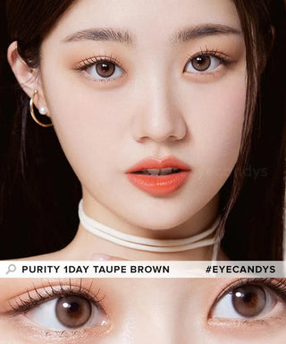 A woman with fair skin wears natural makeup, coral lipstick, and Olola Purity Shine 1-Day Taupe Brown (10pk) lenses. A close-up highlights the lens detail in her eyes. Text reads "Olola Purity Shine 1-Day Taupe Brown #Eyecandys.