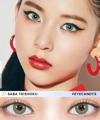 A fair-skinned woman with green eyes, bold eyeliner, red lipstick, and red hoop earrings wears N's Collection Saba Teishoku Green coloured contacts by N's Collection. A close-up highlights the product inspired by Naomi Watanabe.