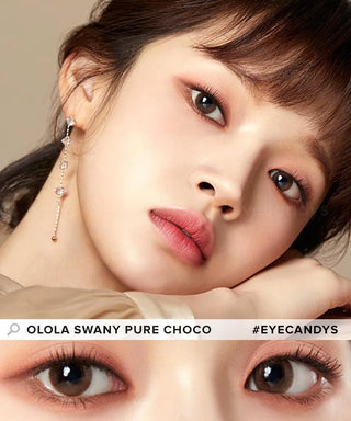 A close-up of a fair-skinned woman wearing Olola Swany Pure Choco contact lenses, soft pink makeup, and a dangly earring. Lower part zooms in on her eyes. Text: "Olola Swany Pure Choco #Eyecandys." Ideal for non-prescription lens lovers.