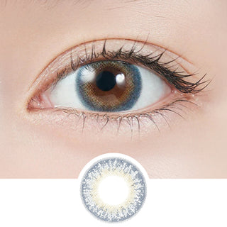 Close-up of eye wearing EyeCandys Lapis 1-Day Lapis Lazuli (10pk) prescription colored contact lens with lens design shown below, sapphire blue three-tone gradient with grey blend and golden-yellow pupil accent, Korean daily disposable blue contact lenses for dark eyes
