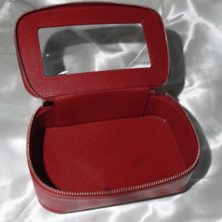 Carmine red Eyecandys Weekender Essentials Case with gold snowflake hardware, travel pouch for organizing beauty essentials and contact lenses.