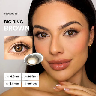A woman with flawless makeup wears EyeCandys Pink Label Big Ring Brown circle lenses for a doll-like look. An inset shows lens details: DIA 14.8mm, G.DIA 14.5mm, B.C 8.8mm, and 3 months use.
