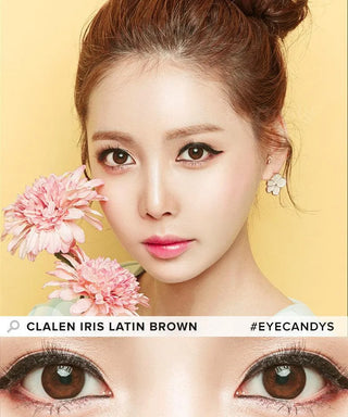 A woman with fair skin and brown hair in a bun holds pink flowers near her face, wearing Clalen Iris Latin Brown (30pk) circle lenses by Clalen, pink lipstick, and floral earrings. Close-up of her brown eyes shown below. Text: "CLALEN IRIS LATIN BROWN #EYECANDYS.