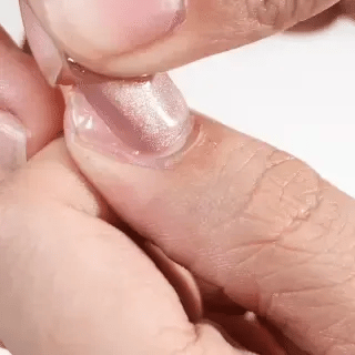 Pressing on EyeCandys press-on nails during application process showing secure fit, easy manicure application, and long-lasting nail wear