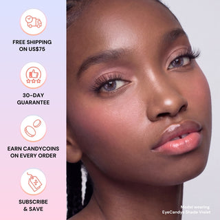 Close-up of a woman with smooth skin and glossy lips wearing EyeCandys Shade Violet Purple contacts, ideal for dark eyes. Icons show perks: free shipping on US$75+, 30-day guarantee, rewards, and subscribe & save.