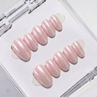 Eyecandys Silk Slip press-on nails featuring a champagne pink chrome finish, glossy glazed effect, and a short oval shape.