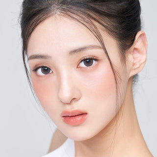 Asian model demonstrating a K-idol-inspired look with 1-Day Grey coloured contact lenses, highlighting the instant brightening and enlarging effect of the circle contact lenses over dark irises.