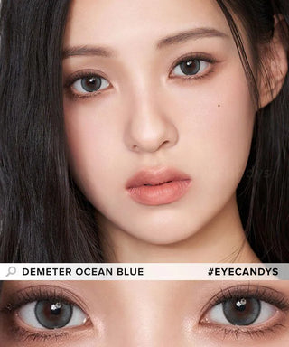 A woman with straight black hair wears Gemhour Demeter 1-Day 13.0 Ocean Blue lenses (10pk), her blue-grey eyes and natural makeup highlighted in a close-up. Text reads "Gemhour Demeter Ocean Blue" and "#EYECANDYS".