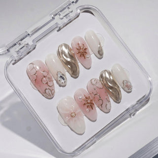 EyeCandys Hanami press on nails featuring soft pink nails with embossed floral relief, chrome wave accent, pearl detail, and silver brushstroke ivory nails.