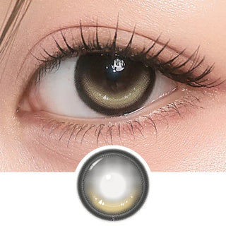 Close-up of eye with long lashes wearing i-Girl One Pick Dear One Beige contact lens from EyeCandys, showing soft beige iris color and detailed lens design