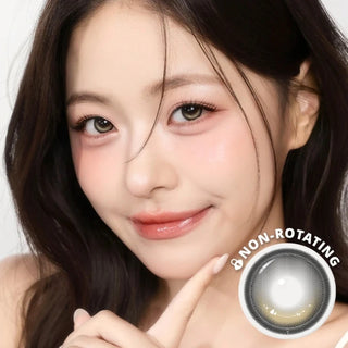 Model wearing i-Girl One Pick Dear One Beige contact lenses from EyeCandys, featuring soft beige iris color, weighted non-rotating design, subtle eye-widening effect, and all-day comfort with silicone hydrogel