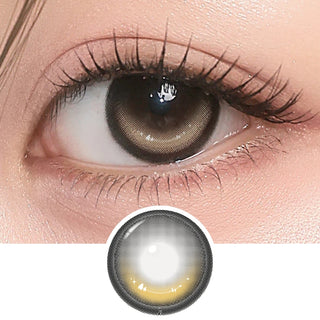 Close-up of eye with long lashes wearing i-Girl One Pick Dear One Honey contact lens from EyeCandys, showing warm honey-brown iris color and detailed lens design