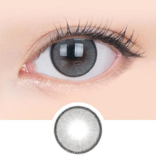 Macro shot of an eye wearing the i-Sha Jadey Mono Grey prescription colour contact lens, showing the multi-colored detail and natural effect on dark brown eyes, with clean eye makeup. At the bottom is the pattern of the colored lens design, showing the dotted detail and pigmentation.