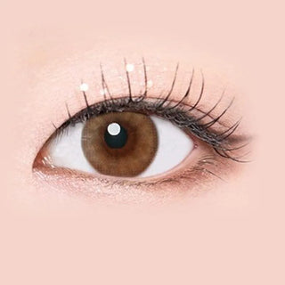 Macro shot of an eye wearing the i-Sha Serenity Brown prescription colour contact lens, showing the multi-colored detail and natural effect on dark brown eyes.