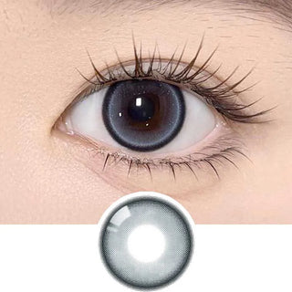 A close-up of a human eye with long lashes wearing Olola Meow Natural Siam Blue contacts by Olola, which enhance the iris. Below, a similar blue lens is shown separately on a white background.
