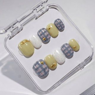 EyeCandys Study Hall press on nails featuring dusty blue plaid nails with red grid lines, sage green nails, and white iridescent glitter accent.