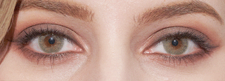 EyeCandys Dewy Hazel opaque color eye contacts on a brown-eyed model with smokey eye makeup, blinking her eyes open