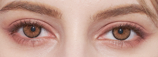 Close-up of brown eyes with natural makeup and well-groomed brows, enhanced by NEO Vision Cosmo Brown circle lenses from NEO Vision for a subtle yet striking look.