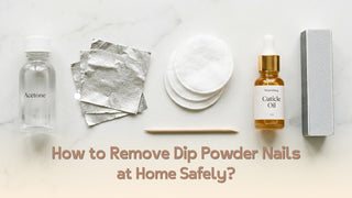 Tools needed to remove dip powder nails at home — acetone, foil, cotton pads, and cuticle oil on marble surface Caption: none
