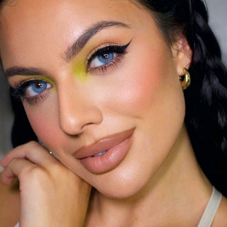 Aqua Blue enlarging contact lens with dark limbal ring on an Asian eye with natural-looking lashes and makeup applied