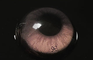Macro shot of Eyecandys i-Sha Reborn Rosywood prescription colored contact lens, showcasing detailed lens design, natural rosywood tones, and texture.