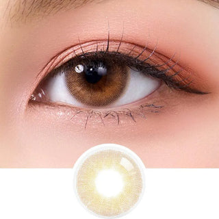 Close-up of a brown eye with natural makeup and long lashes, featuring Olola Able Brown color contact lens by Olola below the eye. The lens has a dark outer ring, is for myopia prescription, and is ideal for dark eyes.
