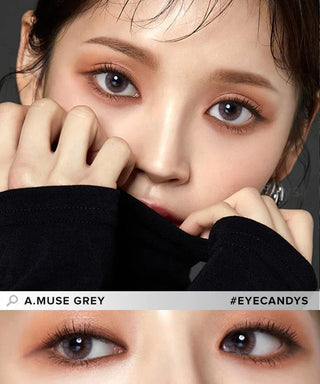 A close-up of a person with flawless skin and dark eyes wearing Olola Amuse Grey contact lenses by Olola for myopia. Their hands partially cover their face, and a zoomed-in image of their eyes appears below. Text reads "Olola Amuse Grey #EYECANDYS.
