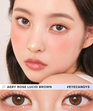 A close-up of a woman with smooth skin, rosy blush, glossy pink lips, and large brown eyes wearing Chuu Aery Rose Lucid Brown (10pk) color contacts by Chuu. A zoomed-in image highlights the natural effect of these brown lenses.
