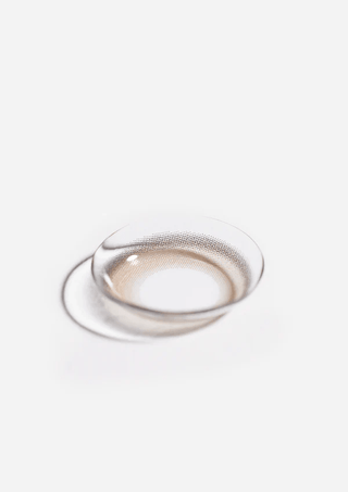 Macro photo of the Eyecandys Aery Rose Lucid Brown prescription colour contact lens, showcasing the thin material and cosmetic lens design.