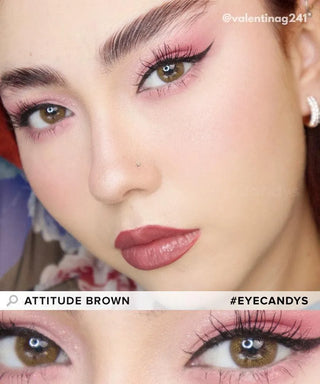 Close-up of a woman wearing EyeCandys Attitude Glitter Brown contacts, bold pink eyeshadow, winged eyeliner, defined brows, and matte mauve lipstick. "EyeCandys Attitude Glitter Brown" and "@valentinag241" in the corner.