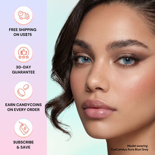 A close-up shows a woman with blue-grey eyes and natural makeup. Beside her are icons for free shipping over $75, 30-day guarantee, rewards, and subscribe & save. Text notes she wears EyeCandys Aura Blue Grey contacts from EyeCandys.
